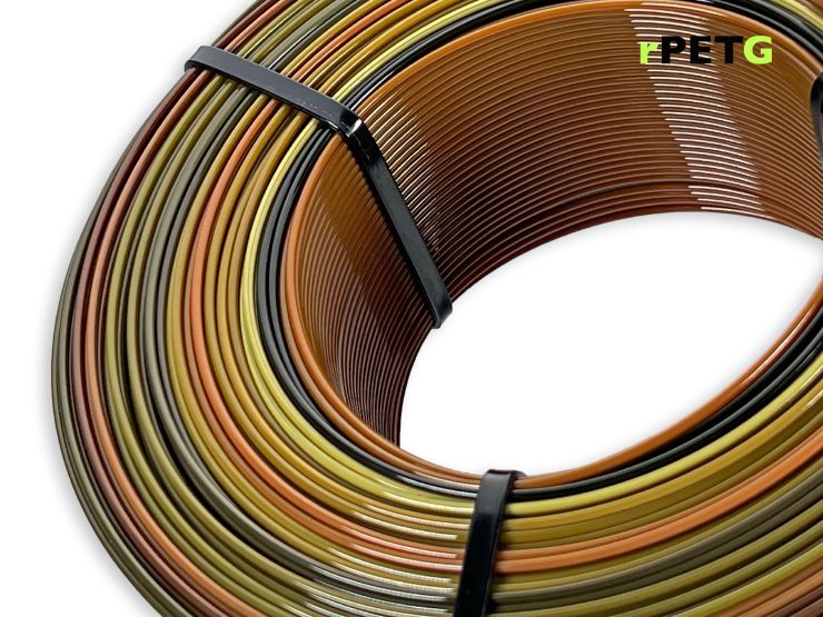 A close up of a refill rPETG spool on white background. We can see the color changing from brown to black to violet.