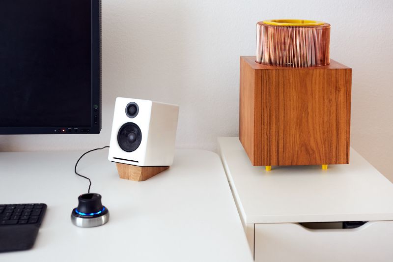 A computer case made out of wood with a large fanless copper heatsink
