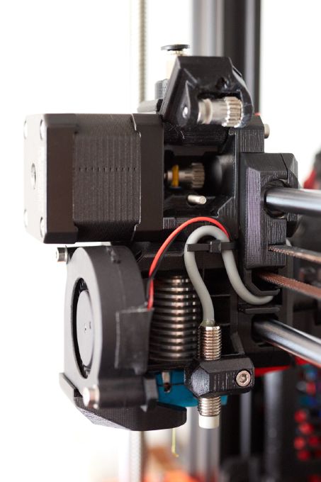 Right side of the BearExxa 1.0 3D printed in black PETG filament. The lid to access the hobb gear is open.