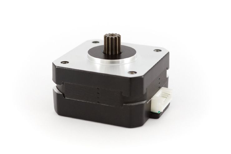 View of a Nema 17 pancake motor laying on its back. The motor gear is coated and has a hole in the middle to reduce the weight