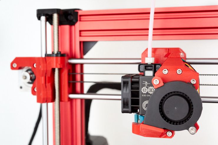 A BearMera and X motor with red PETG parts positioned in the top left corner of a red Bear frame